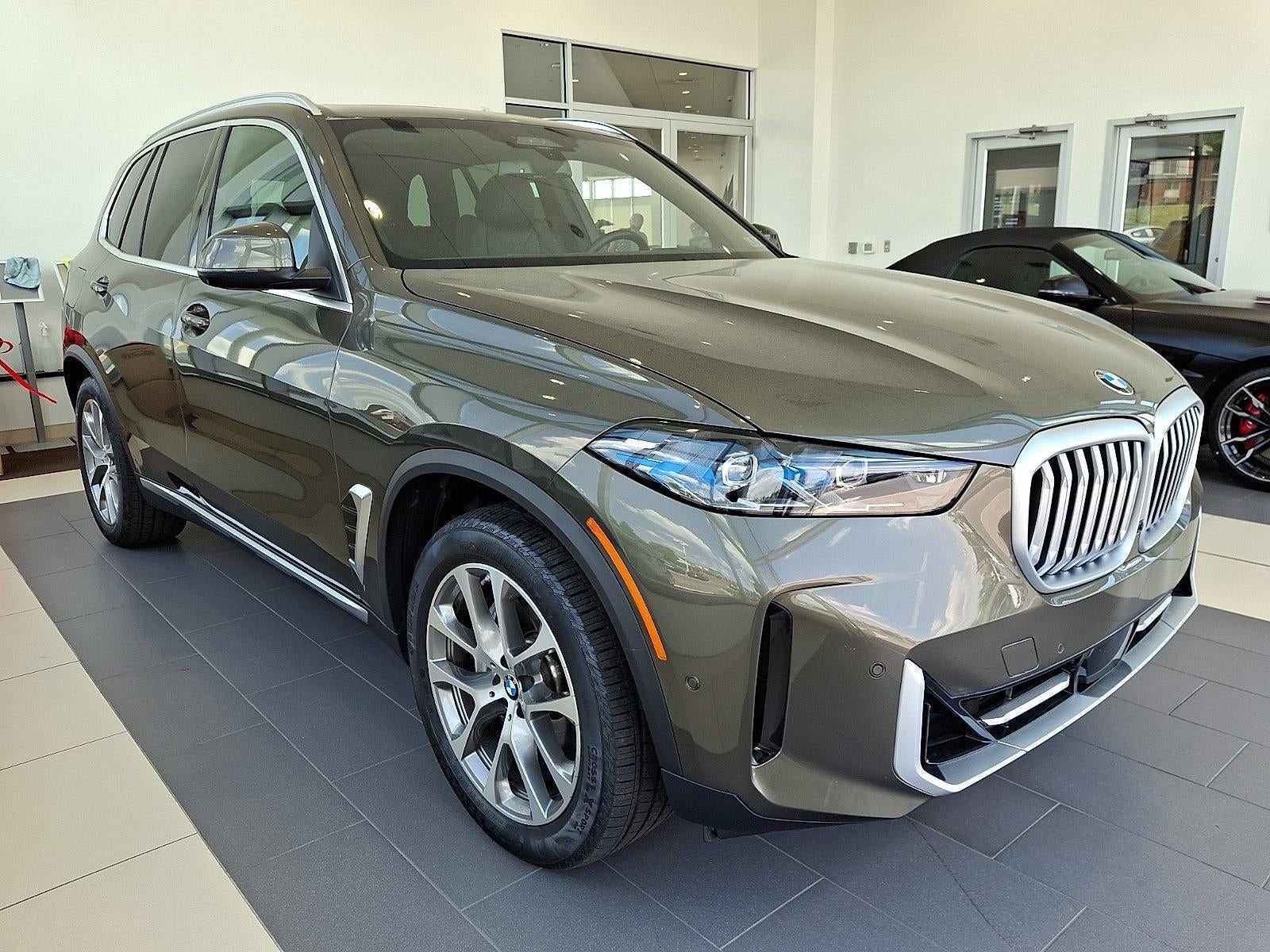 2026 BMW X5 xDrive40i Sports Activity Vehicle in Manhattan Green Metallic — front three-quarter view